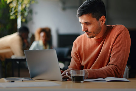 Imagem de um homem olhando para o computador